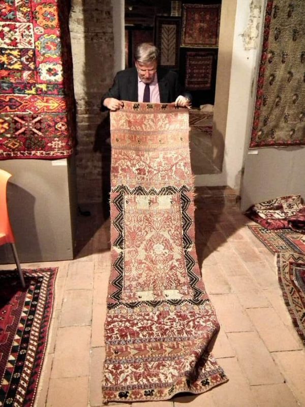 Alberto Boralevi showing a 19th century Sardegnian textile wall hanging.