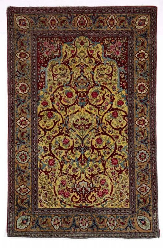 An Isfahan rug, Persia. Niche design of entwined branches, flowers, foliage and bird motifs. Early 20th century. 214 x 139 cm. Estimate euro 1600 - 2000.
