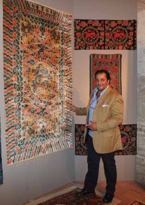 Farzin Mollaian in front of a Chinese silk carpet at Sartirana Textile Show 2014
