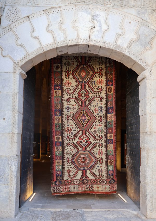 Entrance to the exhibition 'Silk Road Carpet and Kilim Exhibition 2024' at Sultanhani Caravanserai